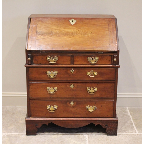 573 - A George II and later mahogany bureau, the fall front opening to a compartmentalised interior, over ... 