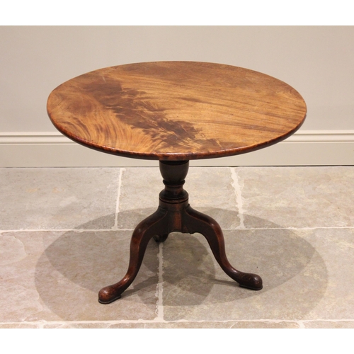 576 - A George III mahogany tilt top tripod table, the circular top raised upon a reduced baluster and rin... 