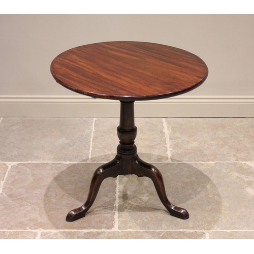 579 - A George III mahogany tripod table, the circular top with a bird cage movement upon an associated ri... 