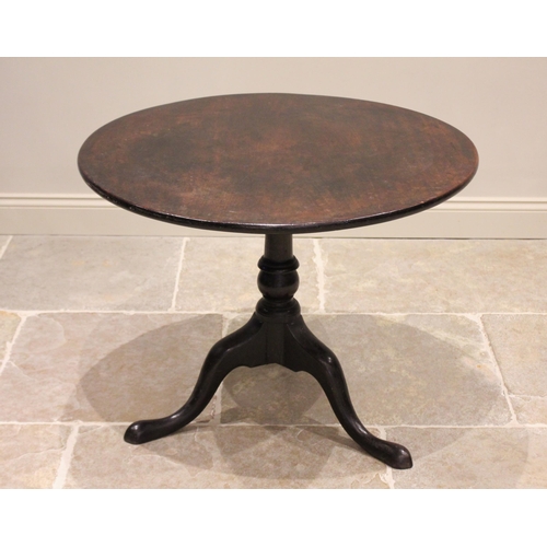 581 - A George III mahogany tripod table, the circular top upon a birdcage movement and a ring turned balu... 