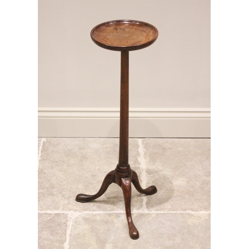 584 - A George III mahogany candle stand or wine table, the circular top with moulded raised rim, raised u... 