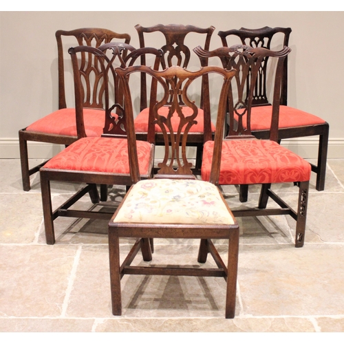 587 - A matched set of six George III mahogany dining chairs, each with a pierced splat back above an upho... 