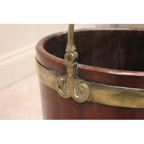 588 - A George III mahogany plate pail/bucket, of coopered form with a brass swing handle extending to scr... 