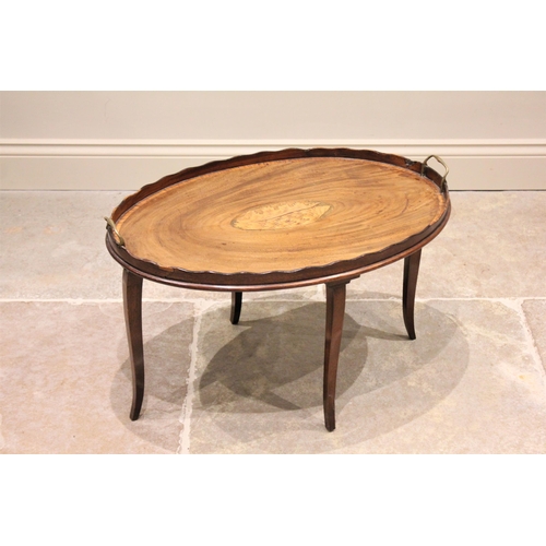 591 - A George III and later mahogany tray top occasional table, the oval galleried tray centred with an i... 