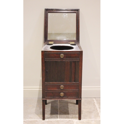 593 - A George III mahogany tambour front washstand, the top opening to a hinged interior mirror and bowl ... 