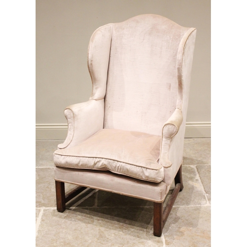 597 - A George III style wing back armchair, 19th century, covered in chenille fabric, the camel back exte... 