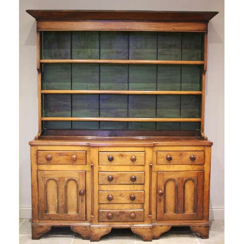 600 - * A George III oak and fruitwood dresser, the high back with a flared cornice above a painted interi... 