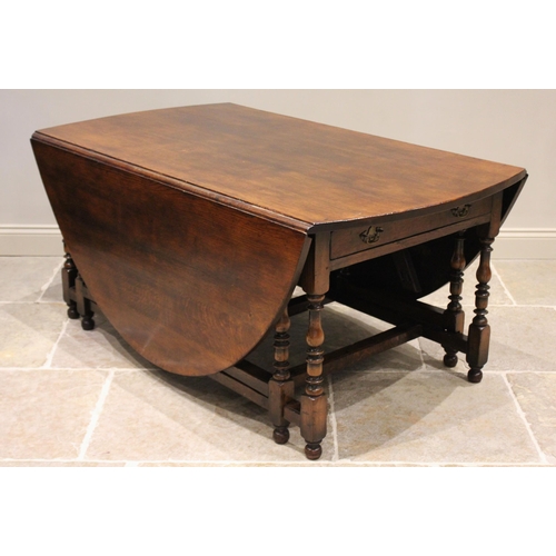 601 - * An 18th century style oak drop leaf table, late 20th century, the oval top above a pair of opposin... 