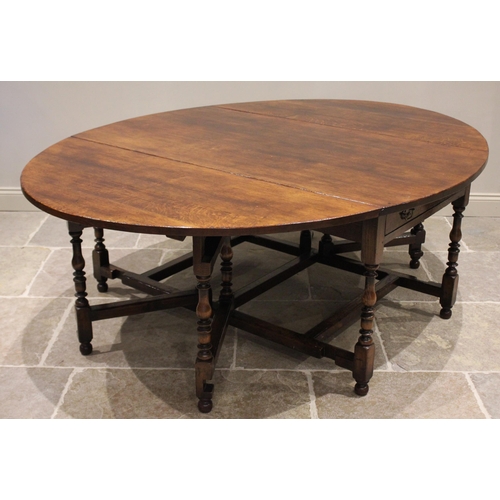 601 - * An 18th century style oak drop leaf table, late 20th century, the oval top above a pair of opposin... 