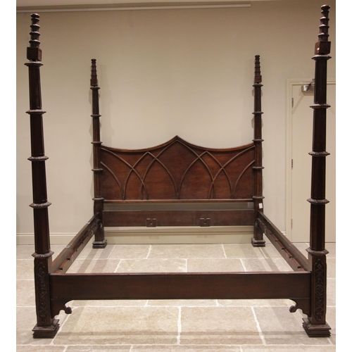 603 - * A Gothic revival hardwood four poster bed, late 20th century, the shaped headboard applied with ar... 