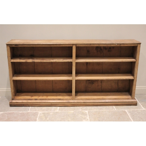 610 - * A Victorian style stripped oak and pine open bookcase, the rectangular moulded top above an arrang... 