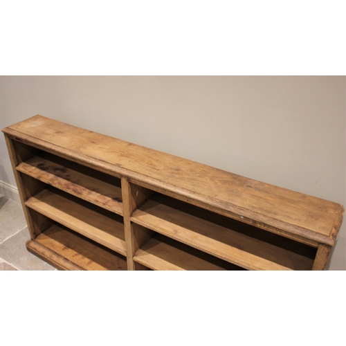 610 - * A Victorian style stripped oak and pine open bookcase, the rectangular moulded top above an arrang... 