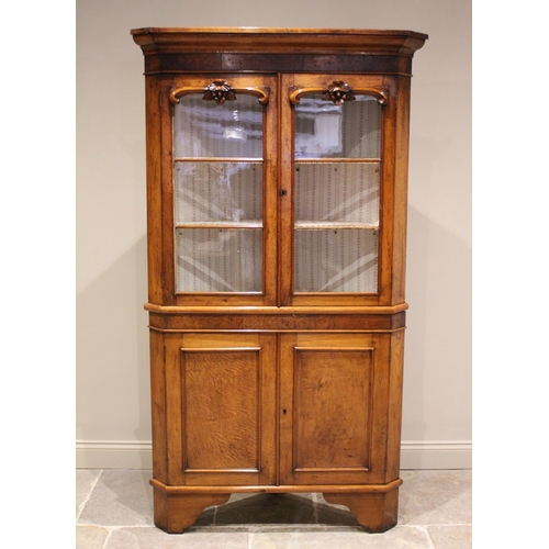 611 - * A 19th century oak and pollard oak freestanding corner cabinet, the moulded cornice above a pollar... 