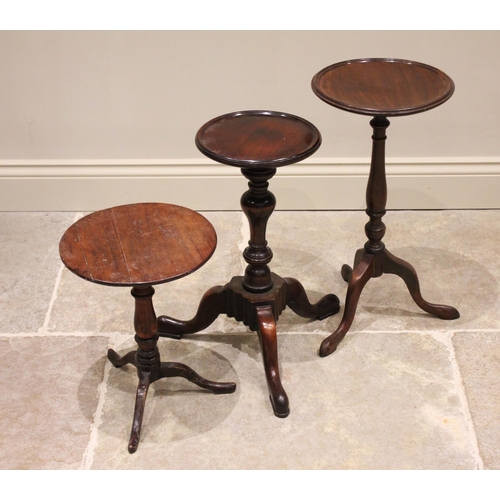 615 - A 19th century mahogany wine table, the circular top with a moulded rim raised upon an inverted balu... 