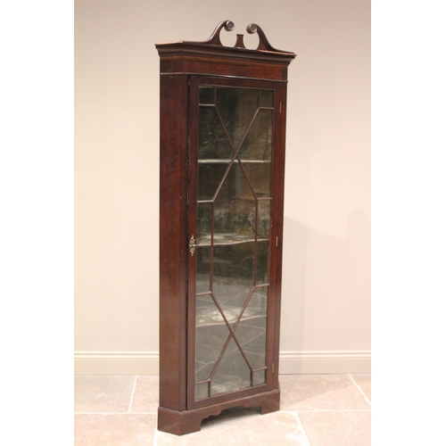 622 - * An Edwardian mahogany freestanding corner display cabinet, with an associated twin swan neck pedim... 