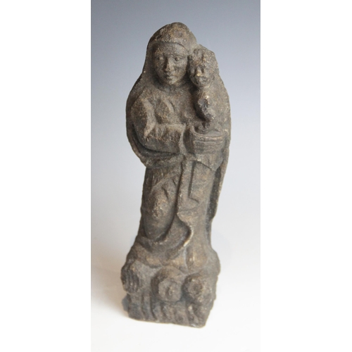 87 - A carved stone model of the Madonna and Child, stylistically modelled on a rocky base, 32.5cm high (... 