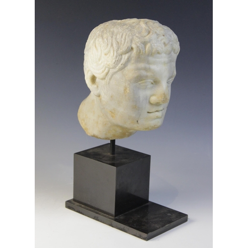 90 - A carved marble male head, in the Roman manner, with curling hair and well defined features, un-carv... 