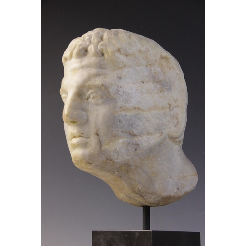 90 - A carved marble male head, in the Roman manner, with curling hair and well defined features, un-carv... 