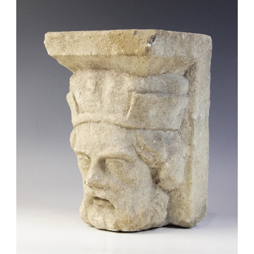 94 - A carved stone corbel, in the medieval style, depicting the head of a bearded gentleman wearing a cr... 