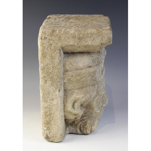 94 - A carved stone corbel, in the medieval style, depicting the head of a bearded gentleman wearing a cr... 