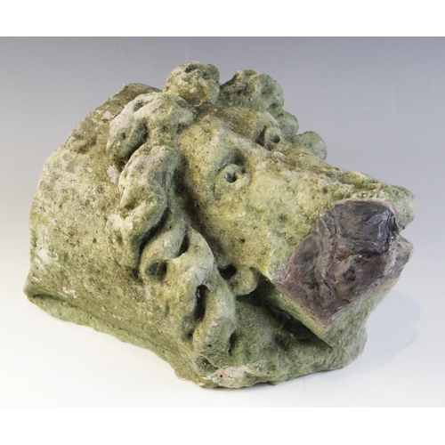 99 - A carved stone corbel, depicting a bearded male head with distinctive flowing hair in the medieval m... 