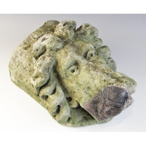 99 - A carved stone corbel, depicting a bearded male head with distinctive flowing hair in the medieval m... 