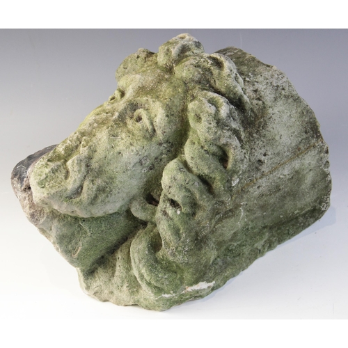 99 - A carved stone corbel, depicting a bearded male head with distinctive flowing hair in the medieval m... 