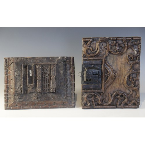 402 - An early 16th century iron lock plate, mounted on a carved oak panel, 19cm x 25.5cm, with a further ... 