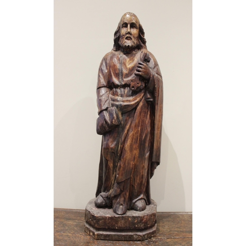 470 - An oak figural carving of St Peter, in the 15th century manner modelled standing, holding keys upon ... 