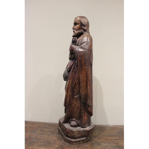 470 - An oak figural carving of St Peter, in the 15th century manner modelled standing, holding keys upon ... 