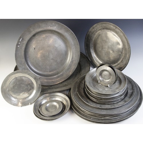 395 - A large selection of pewter chargers, of assorted dates and styles, measuring between 11.6cm and 51c... 