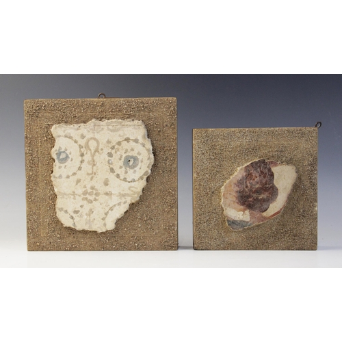 118 - Two polychrome painted fresco fragments; one with circular and foliate motifs on a white background,... 