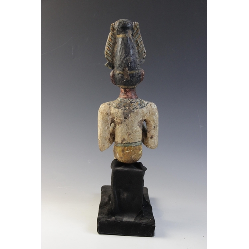 120 - An Egyptian style gesso painted seated wood figure of a pharaoh, wearing the atef crown, Not Ancient... 