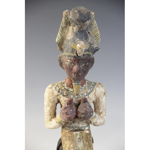 120 - An Egyptian style gesso painted seated wood figure of a pharaoh, wearing the atef crown, Not Ancient... 