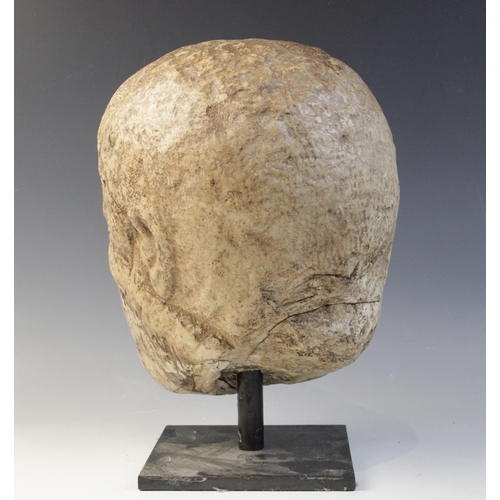 122 - A worn marble male head carved with deeply furrowed brow, with restorations, 26cm high (at fault) 

... 