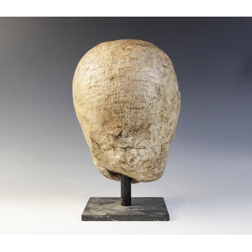 122 - A worn marble male head carved with deeply furrowed brow, with restorations, 26cm high (at fault) 

... 