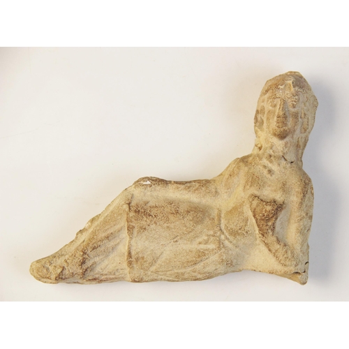 129 - A limestone reclining figure, leaning on the left elbow and holding a drinking cup, probably Parthia... 