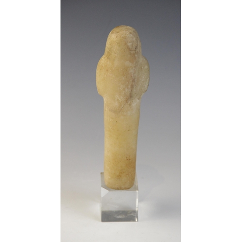 130 - An Egyptian alabaster shabti, some faint traces of the frontal column of hieroglyphic text remaining... 