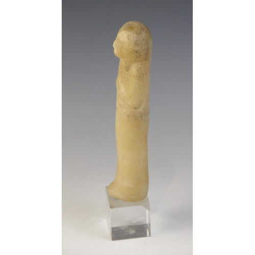 130 - An Egyptian alabaster shabti, some faint traces of the frontal column of hieroglyphic text remaining... 