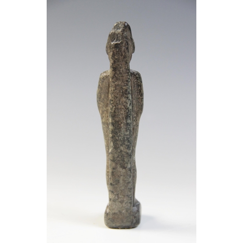 137 - An Egyptian basalt mummiform figure of Osiris, with carved details of the crook and flail, wearing t... 