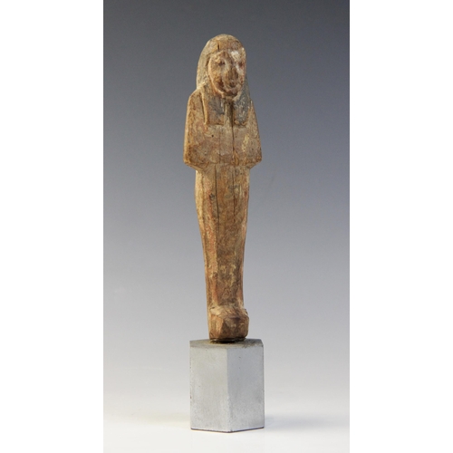 139 - An Egyptian wood shabti, schematically carved with traces of the original pigment remaining, New Kin... 