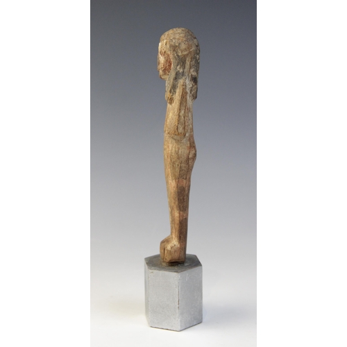 139 - An Egyptian wood shabti, schematically carved with traces of the original pigment remaining, New Kin... 