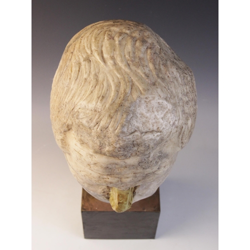 146 - A worn marble male head carved with furrowed brow, with restorations, height excluding base approxim... 