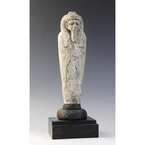 147 - An Egyptian style limestone mummiform figure with lappet wig and false beard, traces of polychrome p... 