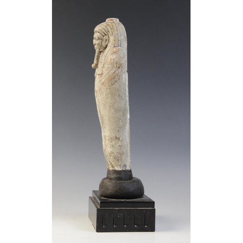 147 - An Egyptian style limestone mummiform figure with lappet wig and false beard, traces of polychrome p... 