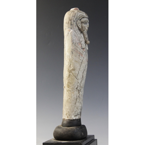 147 - An Egyptian style limestone mummiform figure with lappet wig and false beard, traces of polychrome p... 