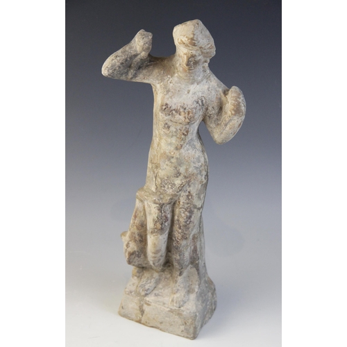 148 - A Hellenistic terracotta figure of Aphrodite Anadyomene, a dolphin at her right leg with its tail wo... 