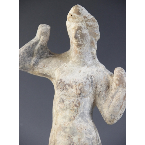 148 - A Hellenistic terracotta figure of Aphrodite Anadyomene, a dolphin at her right leg with its tail wo... 