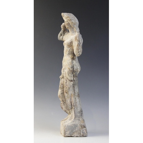 148 - A Hellenistic terracotta figure of Aphrodite Anadyomene, a dolphin at her right leg with its tail wo... 