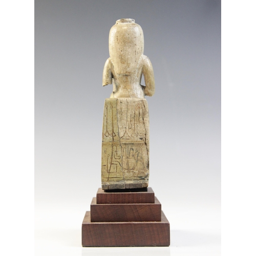 150 - An Egyptian style fragmentary steatite statue of Isis seated on her throne, the figure of the child ... 